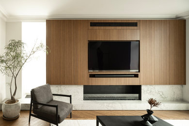 This is an example of an expansive contemporary formal open concept living room in London with brown walls, dark hardwood floors, a stone fireplace surround, a built-in media wall and brown floor.