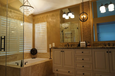 This is an example of a large traditional master bathroom in Los Angeles with raised-panel cabinets, white cabinets, an undermount tub, an alcove shower, beige tile, ceramic tile, beige walls, an undermount sink, granite benchtops and a hinged shower door.