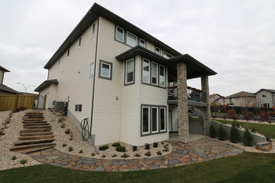 Patio - mid-sized traditional backyard stone patio idea in Edmonton