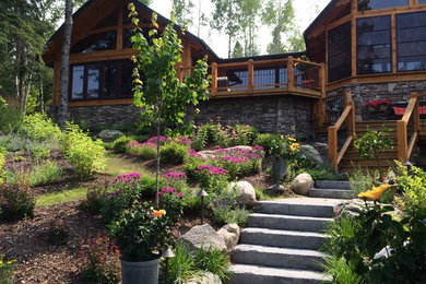 Large rustic brown two-story wood exterior home idea in Other with a shingle roof