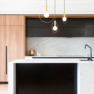 Mid-sized contemporary kitchen pantry ideas - Inspiration for a mid-sized contemporary galley light wood floor kitchen pantry remodel in Sydney with an undermount sink, light wood cabinets, solid surface countertops, white backsplash, marble backsplash, stainless steel appliances and an island