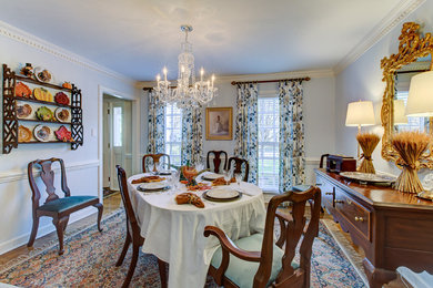Inspiration for a mid-sized timeless light wood floor enclosed dining room remodel in Raleigh with blue walls and no fireplace