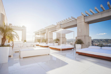 Inspiration for a huge modern backyard tile patio remodel in Los Angeles with a gazebo