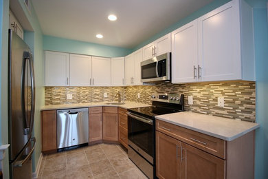 Eat-in kitchen - small coastal l-shaped ceramic tile and beige floor eat-in kitchen idea in Other with an undermount sink, multicolored backsplash, glass tile backsplash, stainless steel appliances and no island