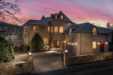 Inspiration for a huge mediterranean brown three-story stone exterior home remodel in Portland with a metal roof