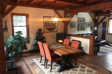 Example of a mid-sized mountain style brown floor great room design in Albuquerque with white walls and no fireplace