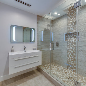 Primary Bath with Backlit Mirror and Pebble Mosaic Floor