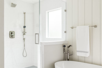 Example of a large transitional master white tile and subway tile cement tile floor, gray floor and double-sink bathroom design in Atlanta with shaker cabinets, white cabinets, a two-piece toilet, white walls, an undermount sink, a hinged shower door, white countertops, a niche and a built-in vanity