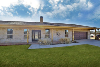 Mid-sized mediterranean one-story stone exterior home idea in Dallas