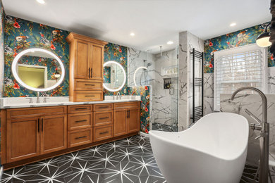 Inspiration for a mid-sized master white tile and porcelain tile porcelain tile, black floor, double-sink and wallpaper freestanding bathtub remodel in Atlanta with shaker cabinets, medium tone wood cabinets, multicolored walls, quartz countertops, white countertops and a built-in vanity
