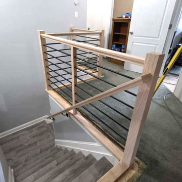 Modern Horizontal Stair Railing with Black Metal Bars and Red Oak T-Rail