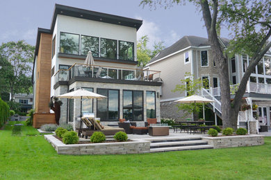 Inspiration for a mid-sized modern full sun backyard concrete paver landscaping in Detroit.