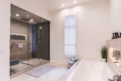 Example of a minimalist master double-sink, porcelain tile and multicolored floor bathroom design in Portland with white cabinets, a one-piece toilet, beige walls, an undermount sink, quartz countertops, a hinged shower door, gray countertops, a built-in vanity and raised-panel cabinets