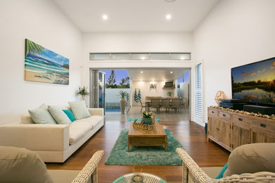 This is an example of a beach style family room in Gold Coast - Tweed.