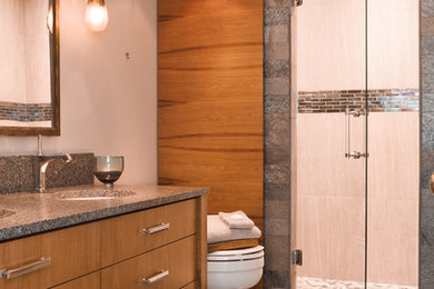Design ideas for a large contemporary master bathroom in Seattle with an alcove shower, a one-piece toilet, gray tile, porcelain tile, white walls, slate floors, an undermount sink, granite benchtops, grey floor, a hinged shower door, flat-panel cabinets and medium wood cabinets.