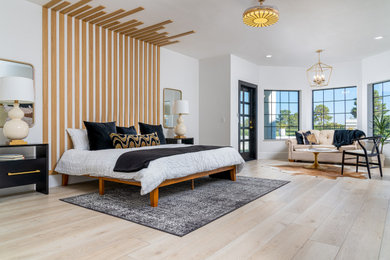 Inspiration for a mid-sized eclectic master light wood floor and beige floor bedroom remodel in Las Vegas with white walls