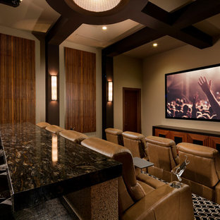 Home theater - southwestern carpeted and black floor home theater idea in Las Vegas with beige walls