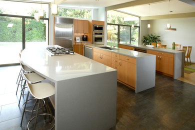 Open concept kitchen - modern galley open concept kitchen idea in Boston with an undermount sink, flat-panel cabinets, light wood cabinets, stainless steel appliances, two islands and quartz countertops