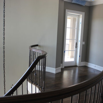 Custom Circular 3-Story Walnut Stair With Iron BalustersS