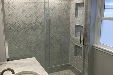 Inspiration for a transitional beige tile and porcelain tile ceramic tile alcove shower remodel in Milwaukee with flat-panel cabinets, gray cabinets, white walls, an integrated sink and solid surface countertops