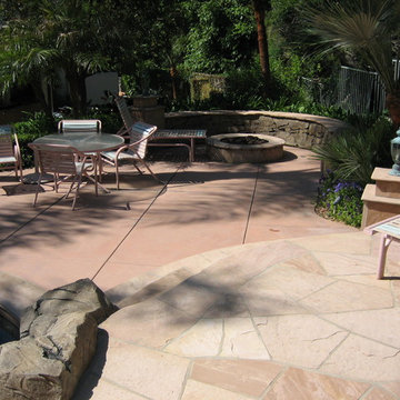 Pool and patio with stone / rock walls and deck