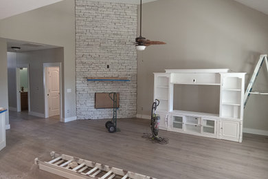 Example of a mid-sized living room design in Other with a standard fireplace and a brick fireplace