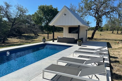 Inspiration for a large country backyard concrete and rectangular natural pool house remodel in Austin