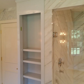 Linen closet beside walk in shower