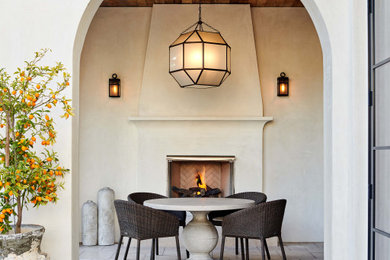 Inspiration for a mid-sized modern backyard tile patio remodel in Los Angeles with a fireplace and a roof extension