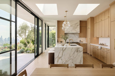 Eat-in kitchen - large 1960s galley vinyl floor eat-in kitchen idea in Los Angeles with flat-panel cabinets, light wood cabinets, marble countertops, white backsplash, marble backsplash, an island and white countertops