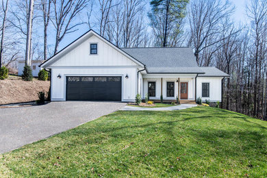 Inspiration for a mid-sized country two-storey white house exterior in Other with concrete fiberboard siding, a gable roof and a shingle roof.