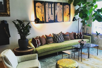 Example of a large eclectic open concept medium tone wood floor and brown floor living room design in Austin with gray walls, no fireplace and a wall-mounted tv
