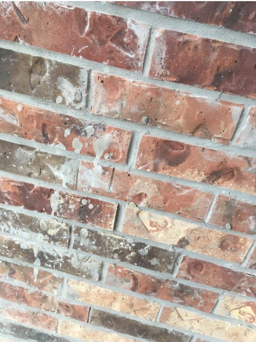 Grey mortar smeared on brick