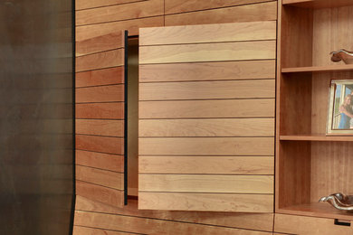 Minimalist light wood floor living room photo in Seattle with a standard fireplace, a metal fireplace and a media wall