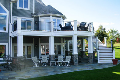 Example of a large classic backyard deck design in Minneapolis with no cover