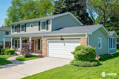Mid-sized traditional gray two-story concrete fiberboard exterior home idea in Chicago with a shingle roof