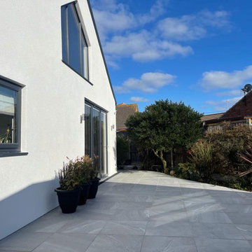 Grey Porcelain Terrace Down the Side of a Rendered House