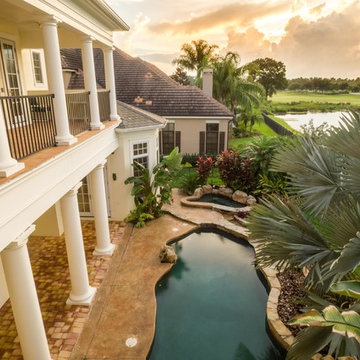 Resort style pool with lake and golf course view.
