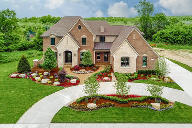 Example of a large classic two-story brick exterior home design in Detroit