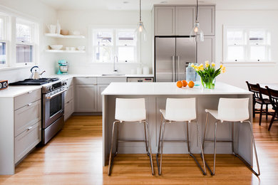 This is an example of a transitional l-shaped kitchen in Vancouver with grey cabinets and with island.