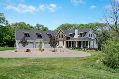 Cottage white two-story mixed siding and board and batten exterior home idea in Minneapolis with a mixed material roof and a black roof