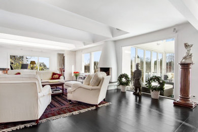 Large danish formal and open concept dark wood floor, black floor and wallpaper living room photo in London with beige walls, no fireplace and a wall-mounted tv
