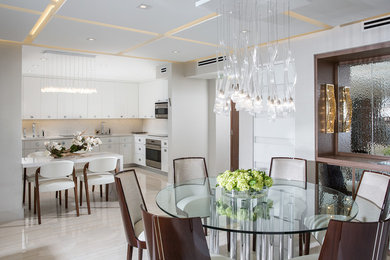 This is an example of a mid-sized contemporary u-shaped separate kitchen in Miami with an undermount sink, flat-panel cabinets, white cabinets, quartz benchtops, white splashback, stone slab splashback, stainless steel appliances and a peninsula.