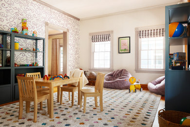Transitional gender-neutral medium tone wood floor, brown floor and wallpaper playroom photo in Boston with white walls