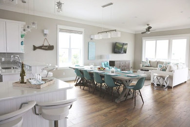 Beach style light wood floor great room photo in Miami with beige walls and no fireplace