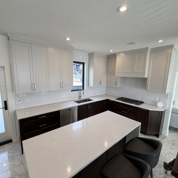 Two-Tone Kitchen with Statuario Waterfall Island and Ceiling-Height Cabinets