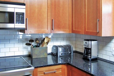 Example of a trendy kitchen design in Vancouver with shaker cabinets, medium tone wood cabinets and quartz countertops