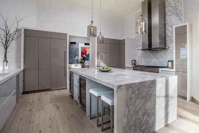 Enclosed kitchen - large contemporary l-shaped light wood floor and brown floor enclosed kitchen idea in Other with an undermount sink, flat-panel cabinets, gray cabinets, marble countertops, white backsplash, marble backsplash, stainless steel appliances, an island and white countertops