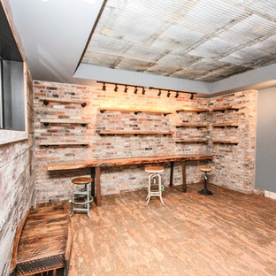 Design ideas for a large farmhouse look-out basement in Indianapolis with beige walls, painted wood flooring, no fireplace and red floors.