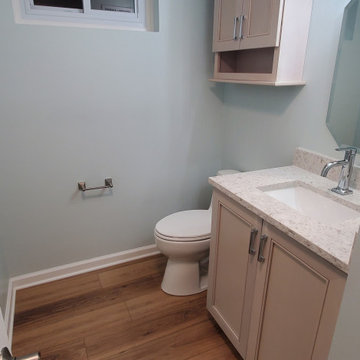Fiinshed basement half bath, custom quartz countertop, luxury vinyl plank floor.